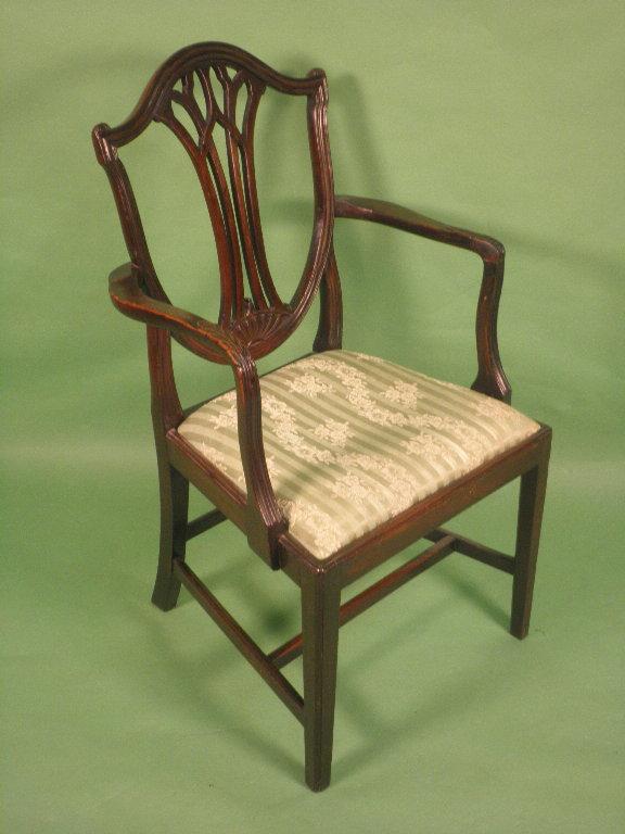 Appraisal: A mahogany open armchair with a shield shape back leaf