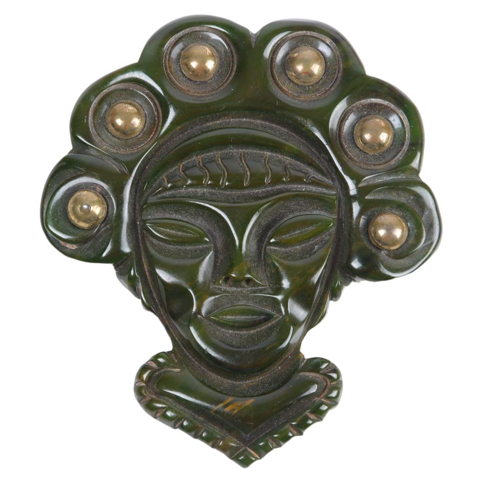 Appraisal: BAKELITE MAYAN GREEN GODDESS FACE BROOCH WITH BRASS STUDS H