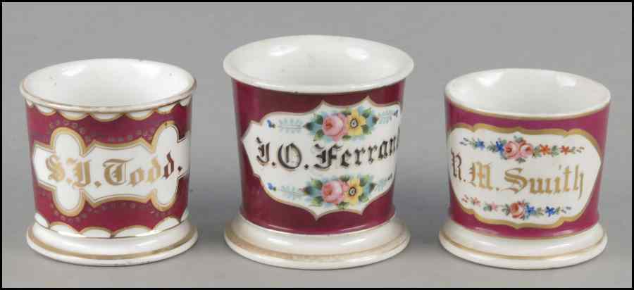 Appraisal: THREE SHAVING MUGS All three with red backgrounds and gilt