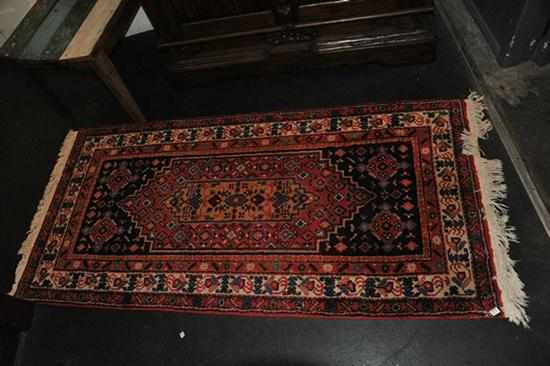 Appraisal: A WOOLEN PERSIAN RUG IN RED AND DEEP BLUE TONES