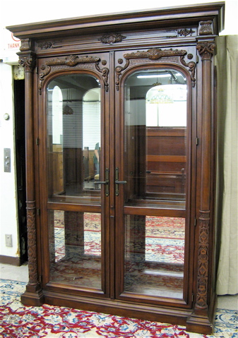 Appraisal: CARVED MAHOGANY AND BEVELED GLASS DISPLAY CABINET Renaissance style having