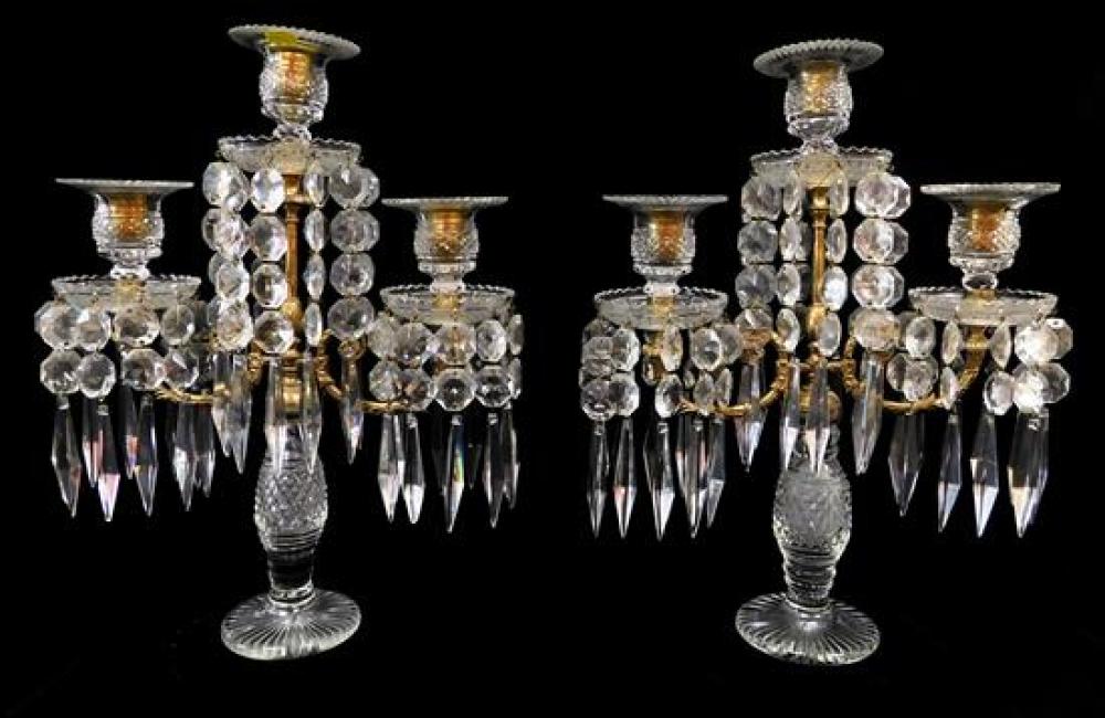 Appraisal: Pair of brass and cut crystal three light candelabras with