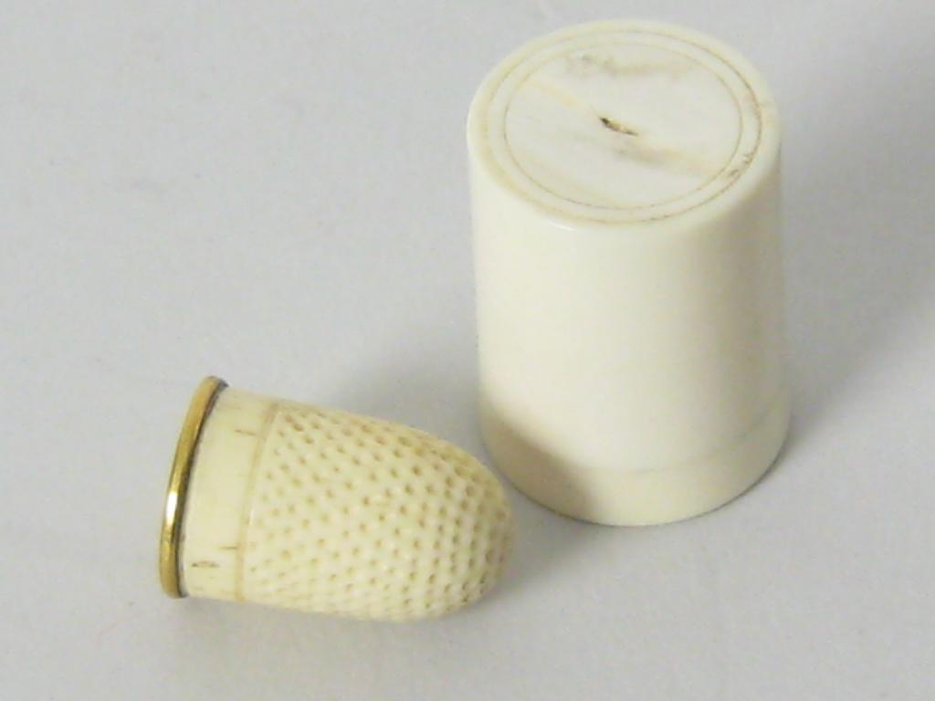 Appraisal: A carved ivory Thimble with gold rim in cylindrical ivory