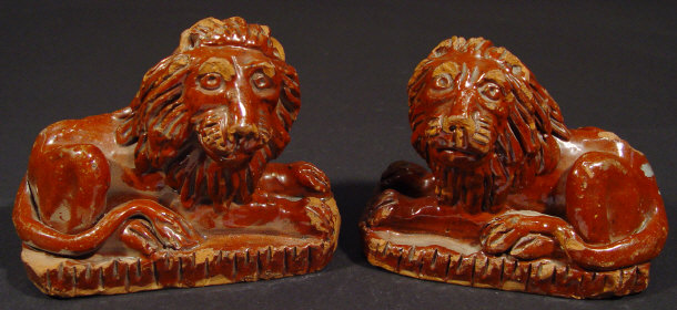 Appraisal: Pair of th Century glazed terracotta recumbent lions cm high