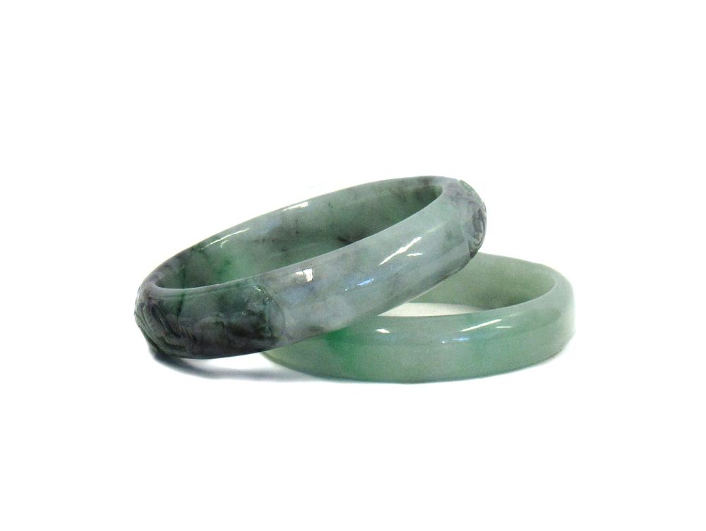 Appraisal: Two Green Jade Bangles One carved with dragons and floral