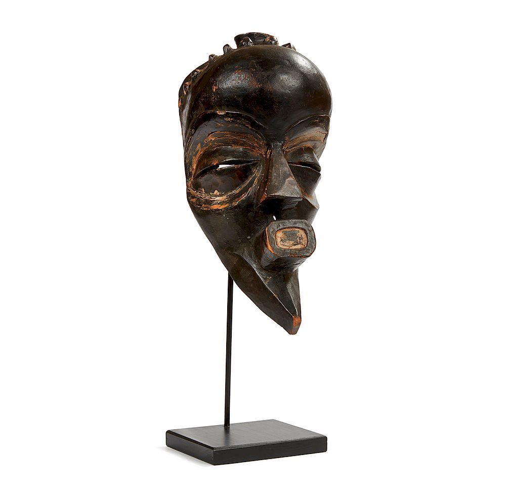 Appraisal: Mbangi mask Mbangi carved wood mask mounted to stand Dimensions