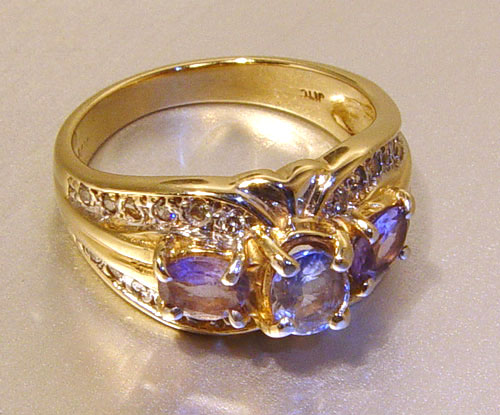 Appraisal: TANZANITE AND DIAMOND RING K yellow gold ring with oval