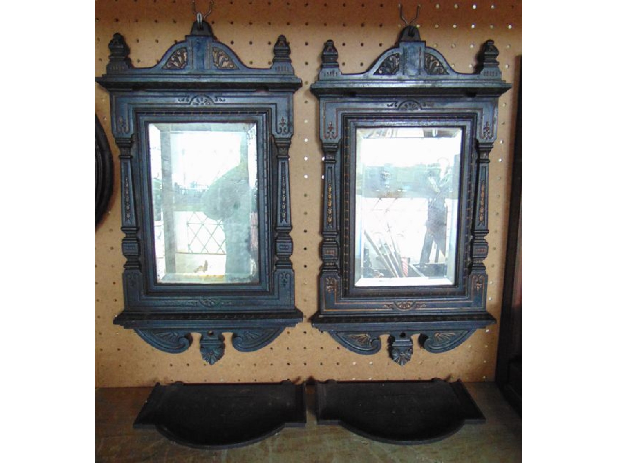 Appraisal: A pair of Victorian heavy cast iron framed wall mirrors