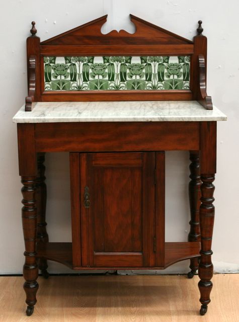 Appraisal: An Edwardian marble topped stained pine washstand with tiled back