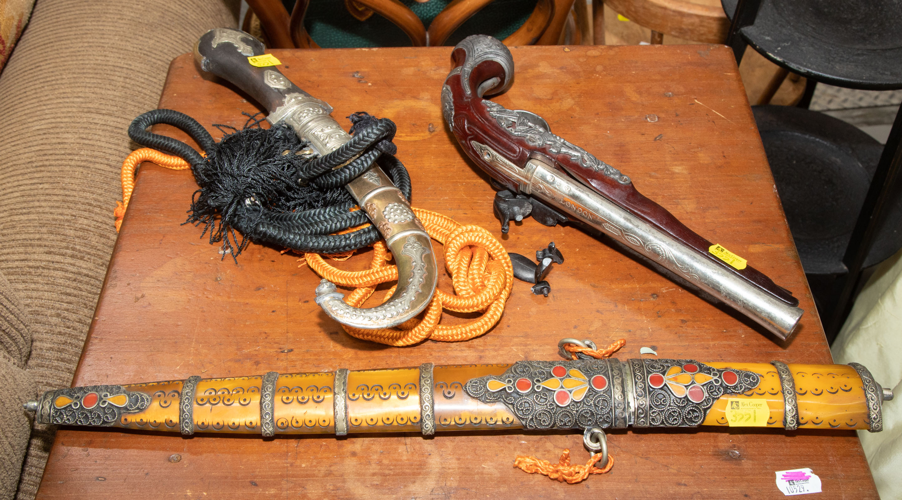 Appraisal: THREE DECORATIVE WEAPONS Includes two Middle Eastern style edged weapons