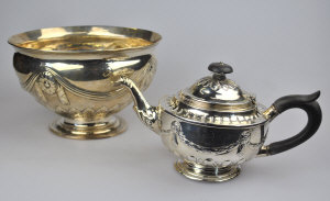 Appraisal: A Victorian silver bachelor teapot embossed with swags on writhen