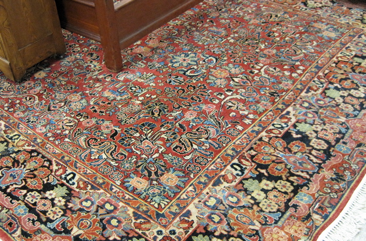 Appraisal: SEMI-ANTIQUE PERSIAN SAROUK CARPET overall floral design on red ground