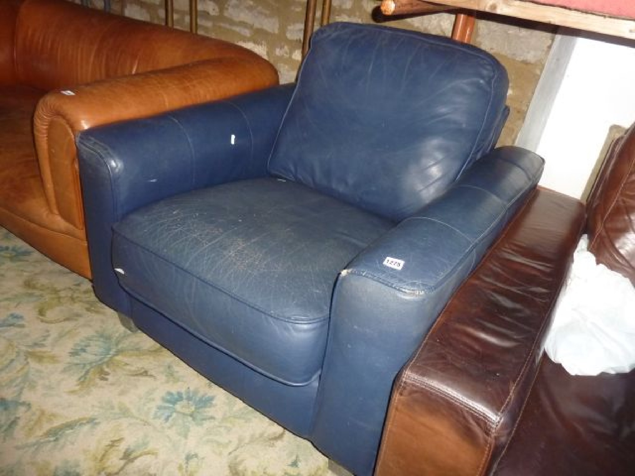 Appraisal: A retro club armchair upholstered in blue with loose cushion