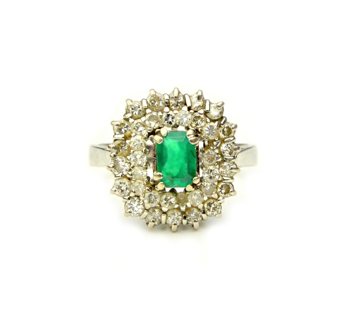 Appraisal: A white gold emerald and diamond cluster ring claw set