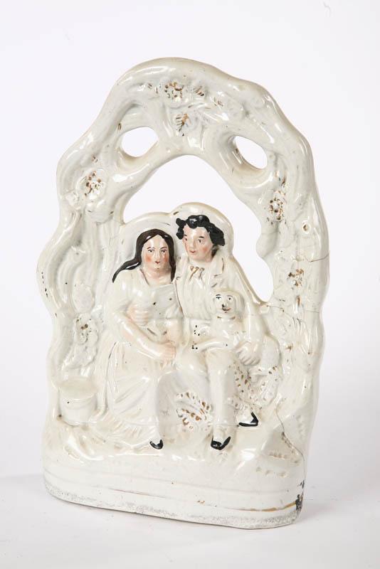 Appraisal: STAFFORDSHIRE FIGURE GROUP A man and woman with their dog