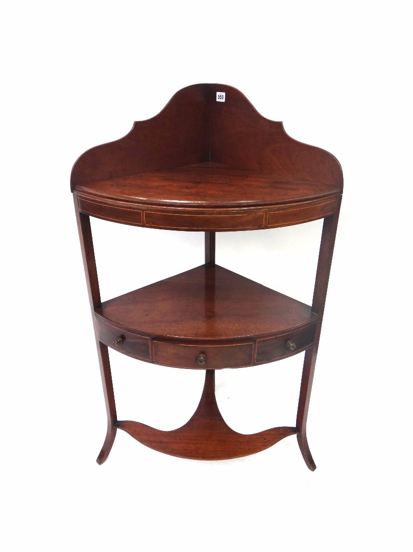 Appraisal: A George III mahogany boxwood strung bowfront three tier corner