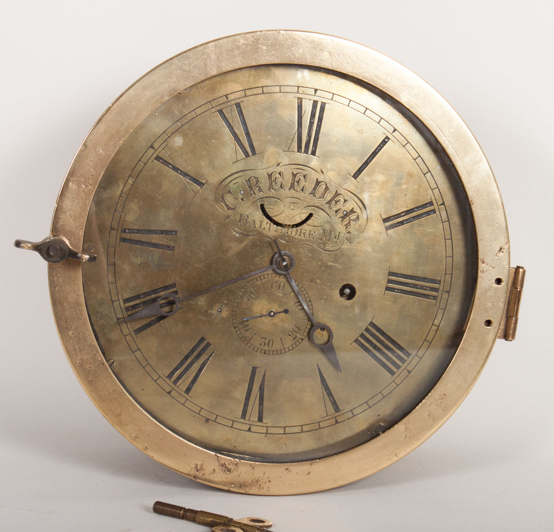 Appraisal: American brass porthole ship's clock th century circular brass clock