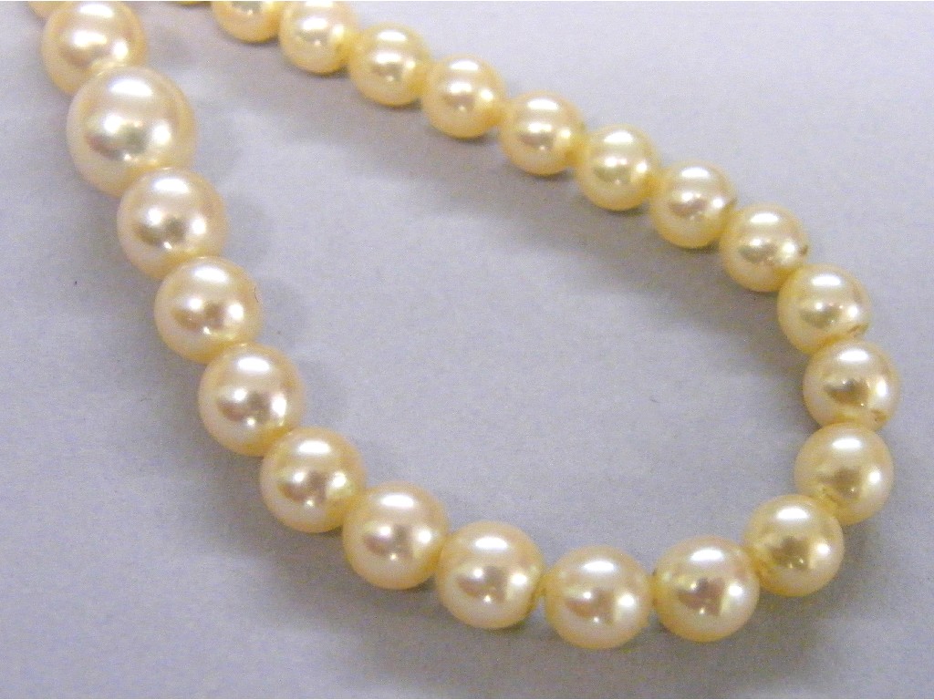 Appraisal: Single row pearl necklet with a ct bow clasp long