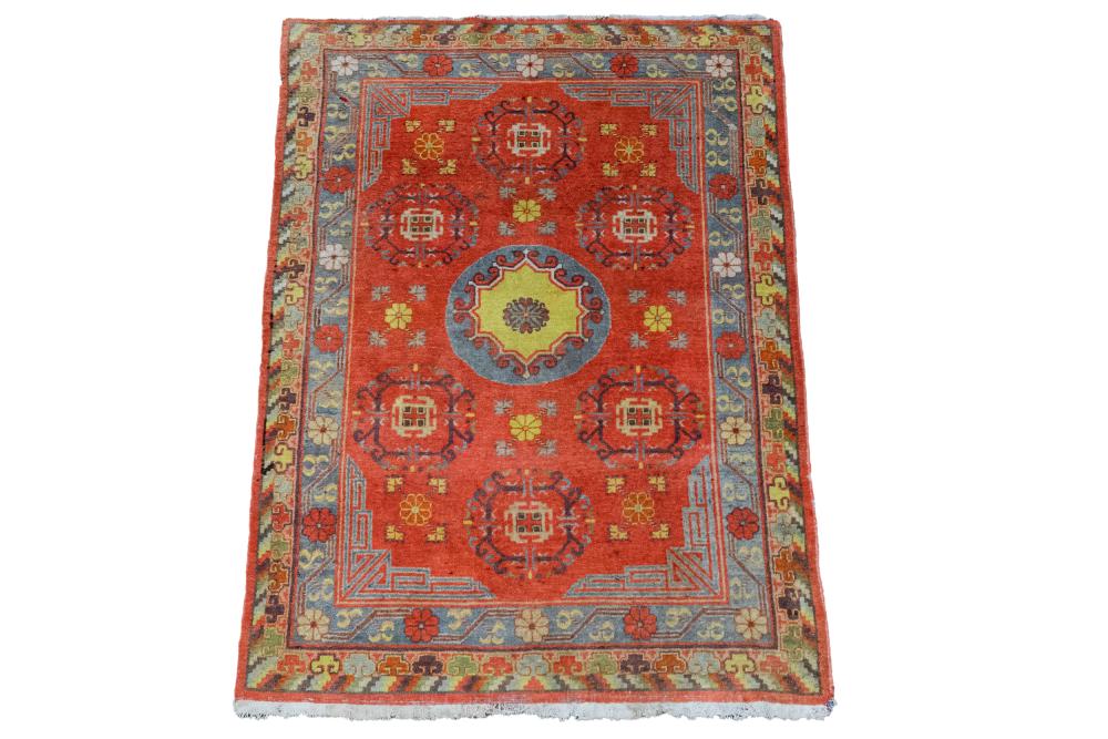 Appraisal: TURKISH KHOTAN STYLE CARPETwith a bright colored central medallion '