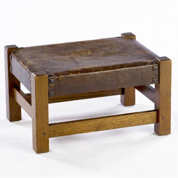 Appraisal: GUSTAV STICKLEY Low footstool wrapped in original hard leather with