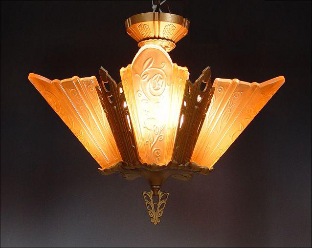 Appraisal: VINTAGE ART DECO CHANDELIER lights covered by amber glass shades