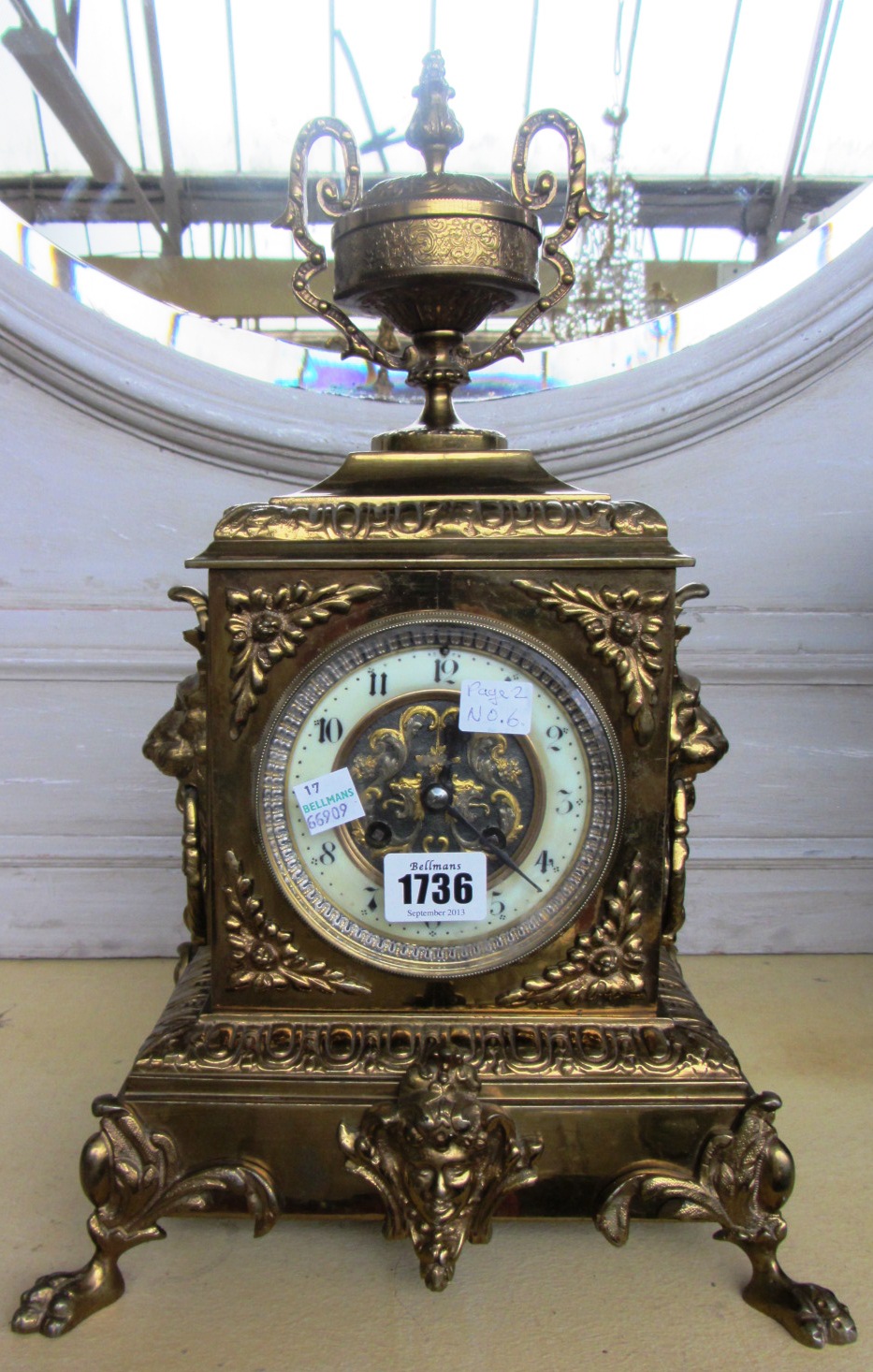 Appraisal: A continental gilt brass cased mantel clock with urn surmount