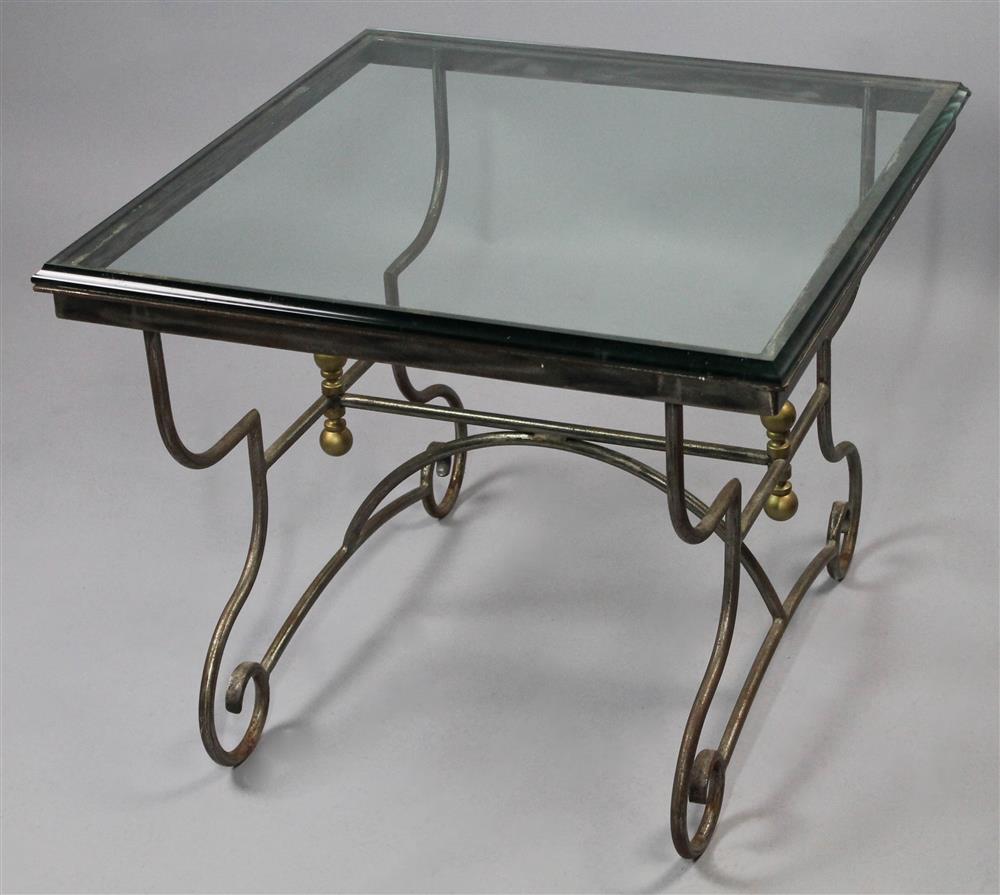 Appraisal: BEVELED SQUARE GLASS COFFEE TABLE with scrolling brass finial topped