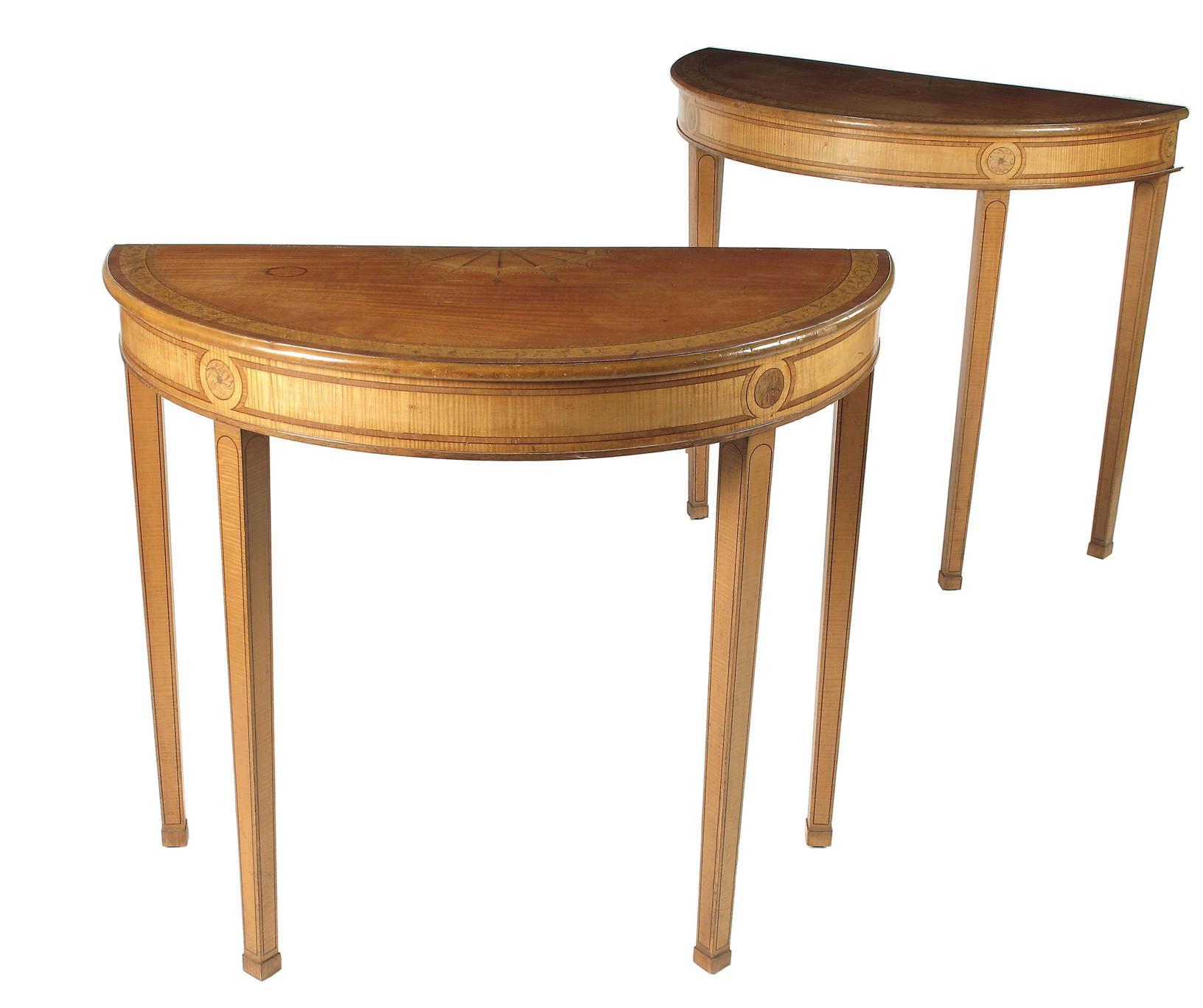 Appraisal: A pair of satinwood and marquetry demi-lune console tables