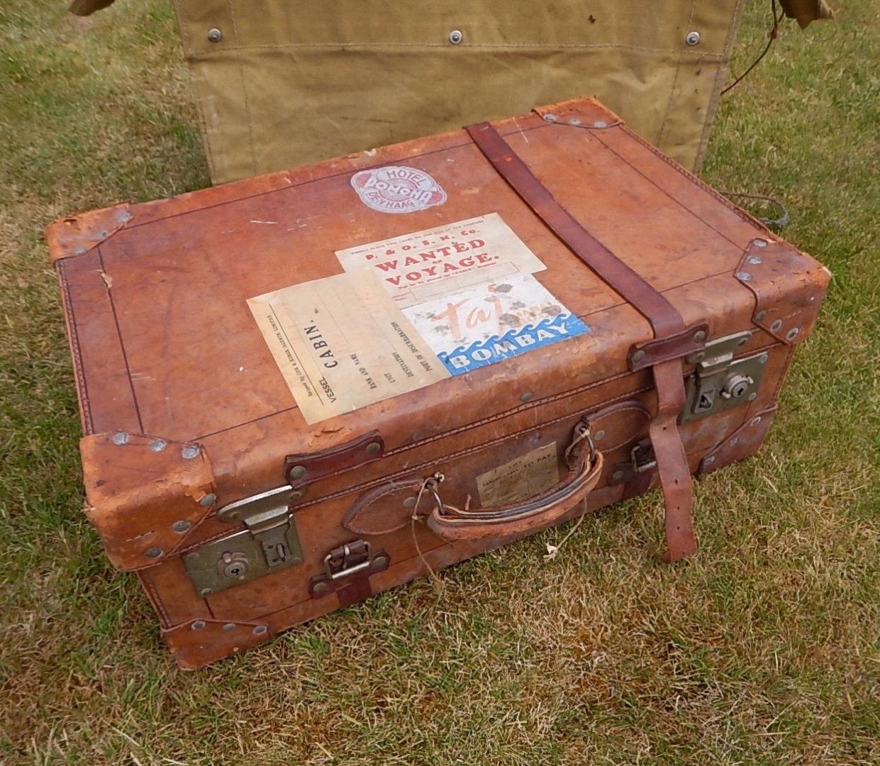 Appraisal: A vintage leather suitcase with LMS luggage label and others