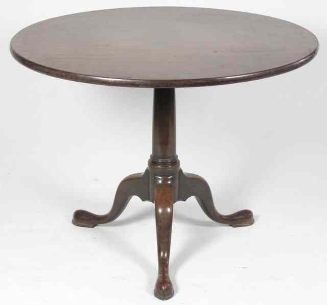 Appraisal: A George II red walnut circular table raised on a