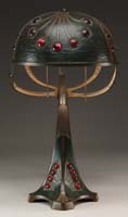 Appraisal: AUSTRIAN WIENER WERKSTATTE-STYLE LAMP With hand-tooled patinated domed shade having