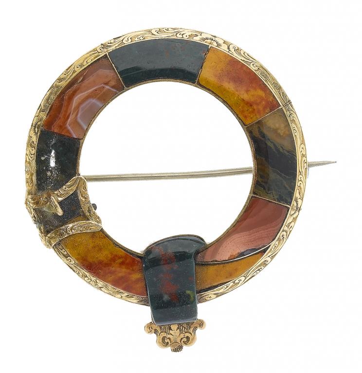 Appraisal: A VICTORIAN ENGRAVED GOLD AND SCOTTISH HARDSTONE GARTER BROOCH