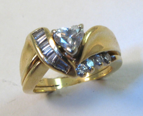 Appraisal: DIAMOND AND FOURTEEN KARAT GOLD RING set with a heart-cut