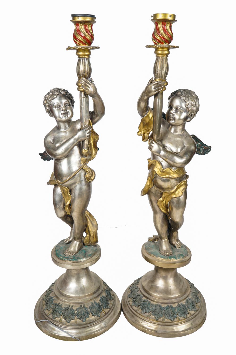 Appraisal: PAIR OF CHERUB TORCHIERE LAMPSpolychrome and silvered bronze Condition with