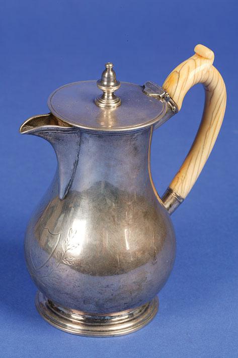 Appraisal: A GEORGE III IRISH HOT WATER POT of baluster form