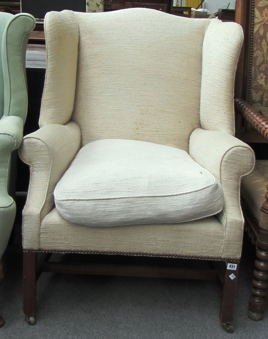 Appraisal: A George III style wingback armchair on square mahogany supports