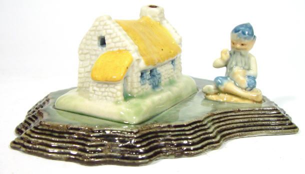 Appraisal: Wade figure of a leprechaun beside a cottage on a