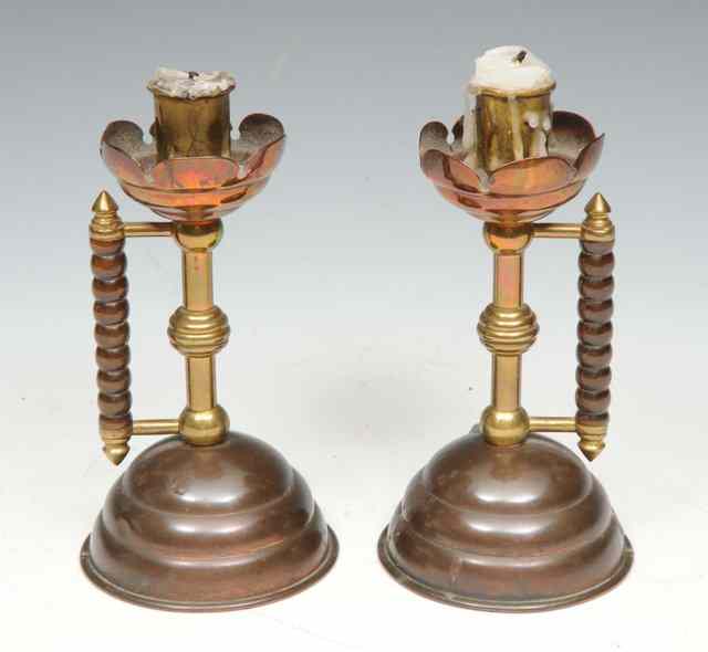 Appraisal: A PAIR OF AESTHETIC MOVEMENT TURNED BRASS AND COPPER CANDLESTICKS