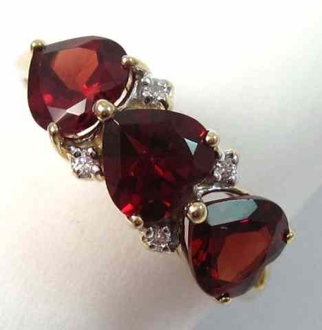 Appraisal: GARNET DIAMOND AND FOURTEEN KARAT GOLD RING set with three