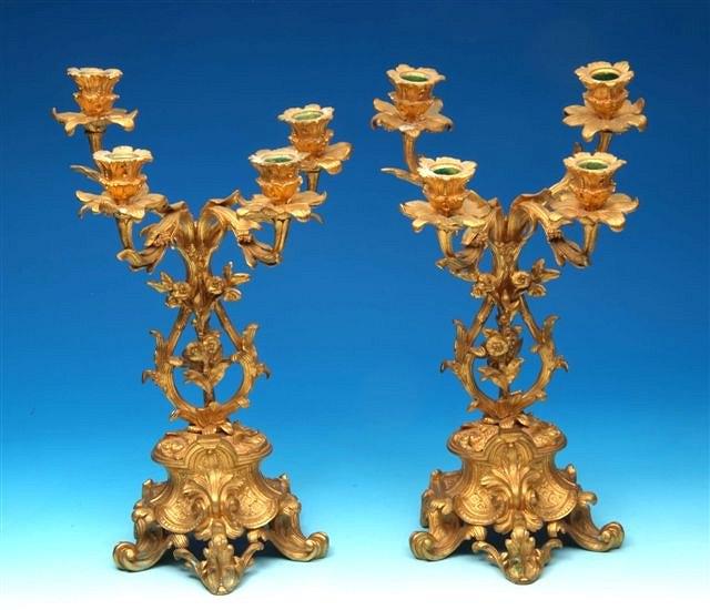 Appraisal: A pair of gilt four branch candelabra each with scrolling