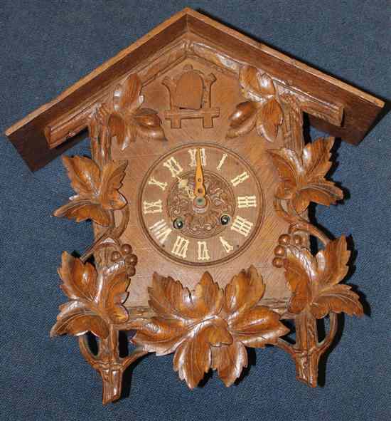 Appraisal: A Black Forest carved wood cuckoo clock with vine carved