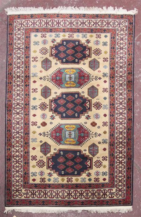 Appraisal: A Kazak style carpet modern the cream field with three