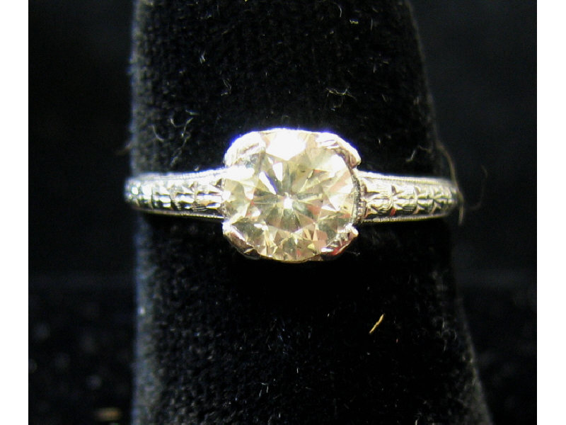 Appraisal: DIAMOND RING Art Deco platinum ring with engraved shoulders centering