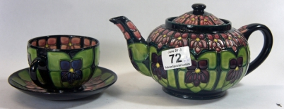 Appraisal: Moorcroft Tea Pot and Cup and Saucer decorated in the