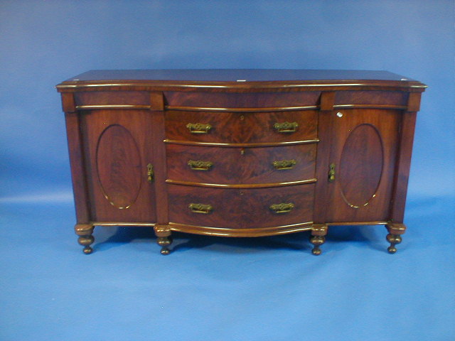 Appraisal: A late Victorian flamed mahogany serpentine sideboard with three drawers