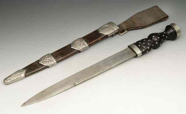 Appraisal: A SCOTTISH DIRK with stylised hardwood handle in leather scabbard