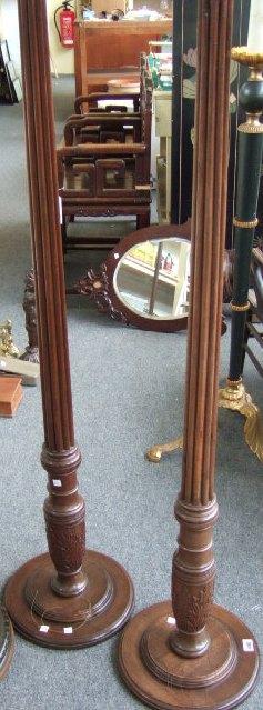 Appraisal: A pair of th century mahogany torcheres with reeded columns