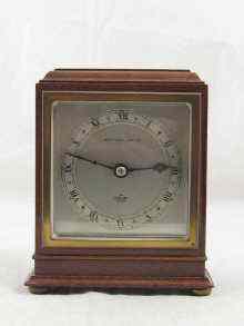 Appraisal: A square faced mahogany clock by Elliott for The Alexander