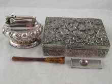 Appraisal: A silver cigar cutter a silver plated table lighter a