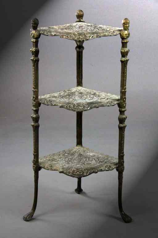 Appraisal: Small Ornate Tiered Corner Brass TableAn elaborately decorated scrolled table